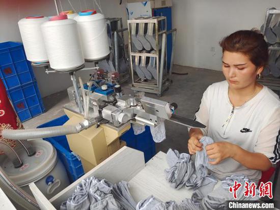 热孜亚·艾买提参与的家庭工坊，其在用空余时间操作，每月收入2000多元。　史玉江 摄