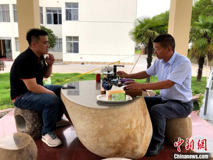 林昆佑(左)和家人讨论最近的生意情况。　朱晓颖 摄
