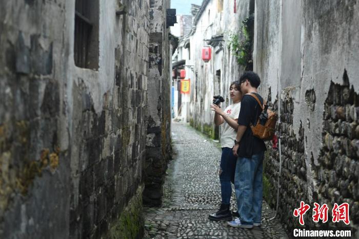 台湾青年在龙门古镇的巷道中拍摄。　王刚 摄